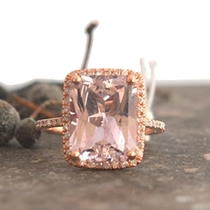 Handmade rose gold engagement ring with certified peach sapphire emerald cut