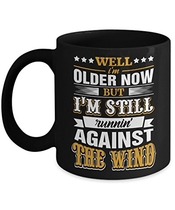 People recommend "TeeCentury Well I'm Older Now But I'm Still Runnin' Against The Wind Mug 11oz"