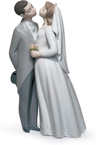 People recommend "LLADRÓ A Kiss to Remember Couple Figurine. Porcelain Bride and Groom Figure"